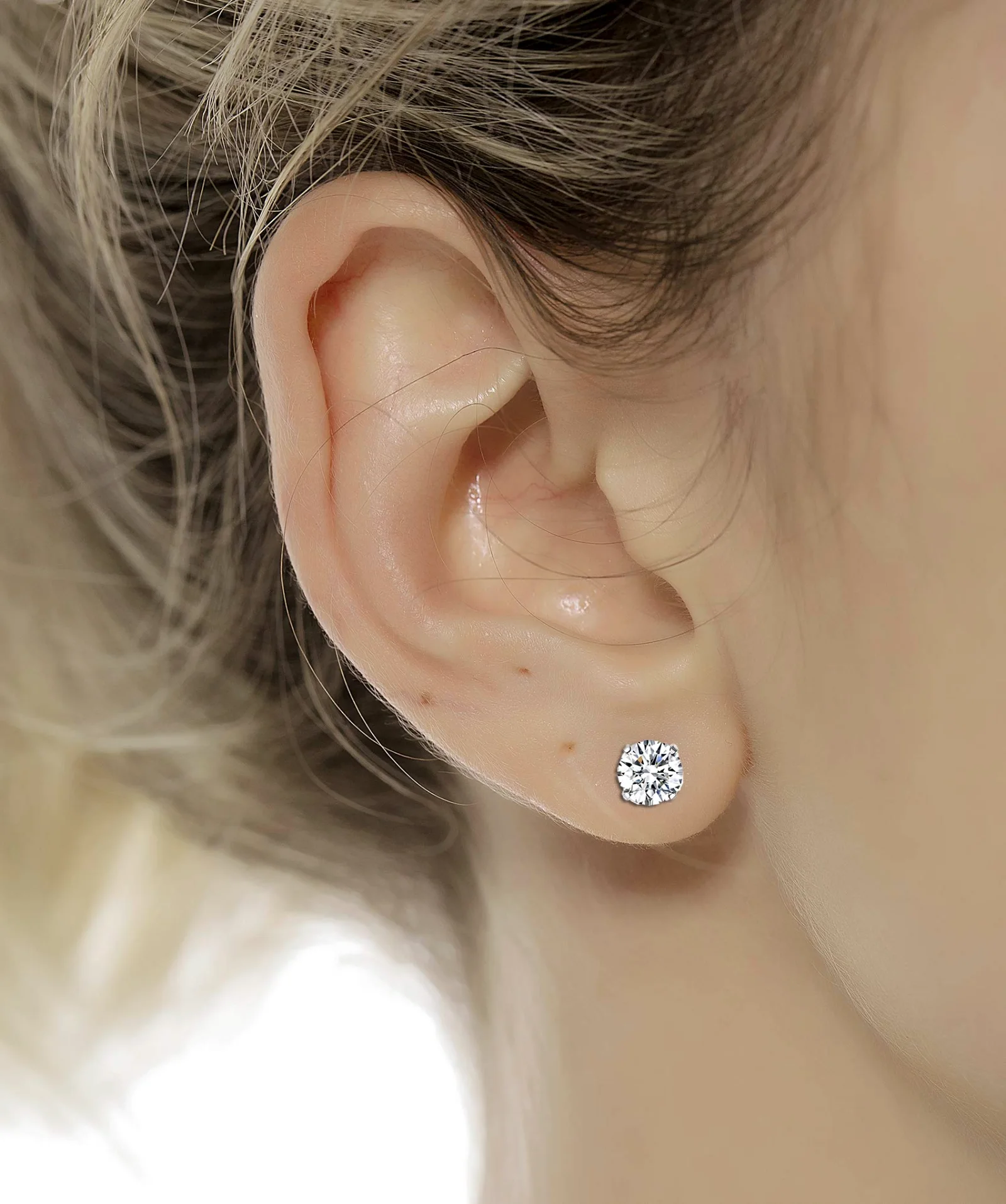 A round CZ stud from a TORNITO graduated set in a lobe
