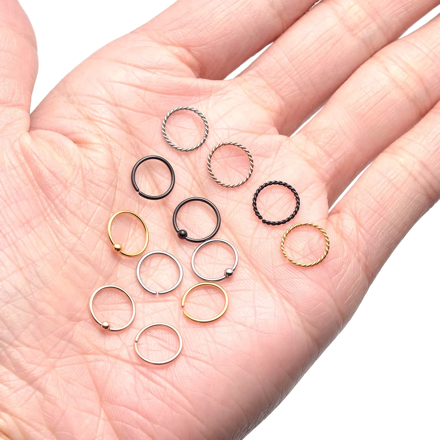A palm holding a TORNITO pack of nose hoops